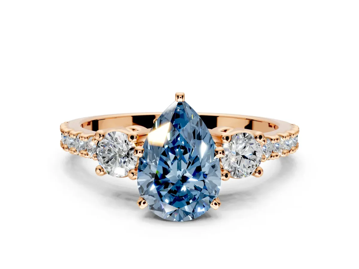 3 Stone Engagement Ring Setting for Fancy Blue Pear-Shaped Center with Round Cut Side Accents and Prong Head in Rose Gold