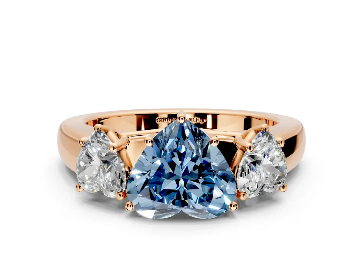 3 Stone Engagement Ring Setting for Fancy Blue Heart-Shaped Center with Raised Basket Heads and Prong Head in Rose Gold