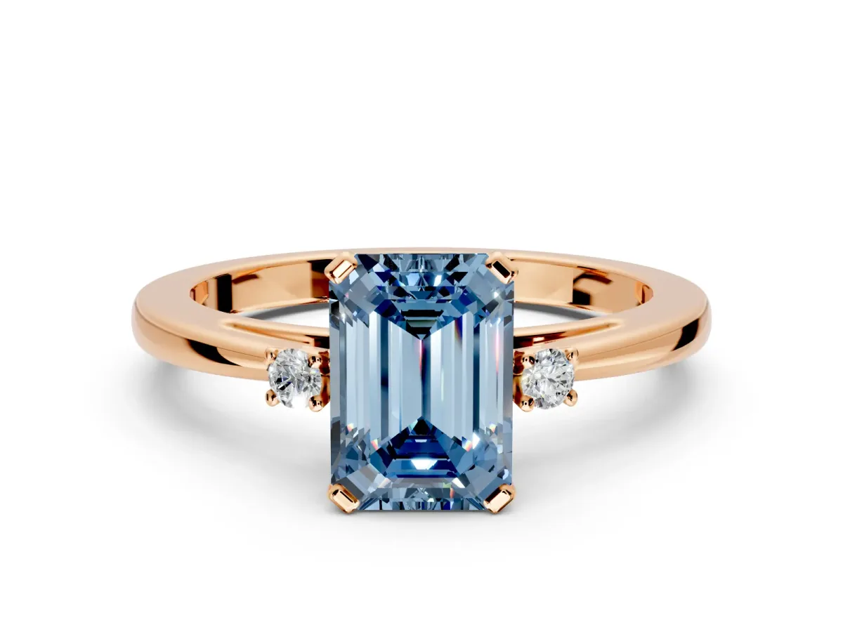 3 Stone Engagement Ring Setting for Fancy Blue Emerald Cut Center with Low-Set Round Cut Accents and Prong Head in Rose Gold