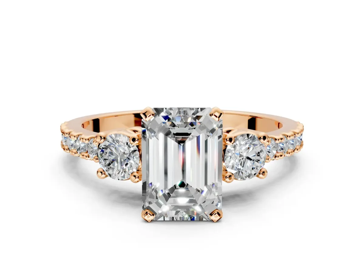 3 Stone Engagement Ring Setting for Emerald Cut Center with Round Cut Side Accents and Prong Head in Rose Gold