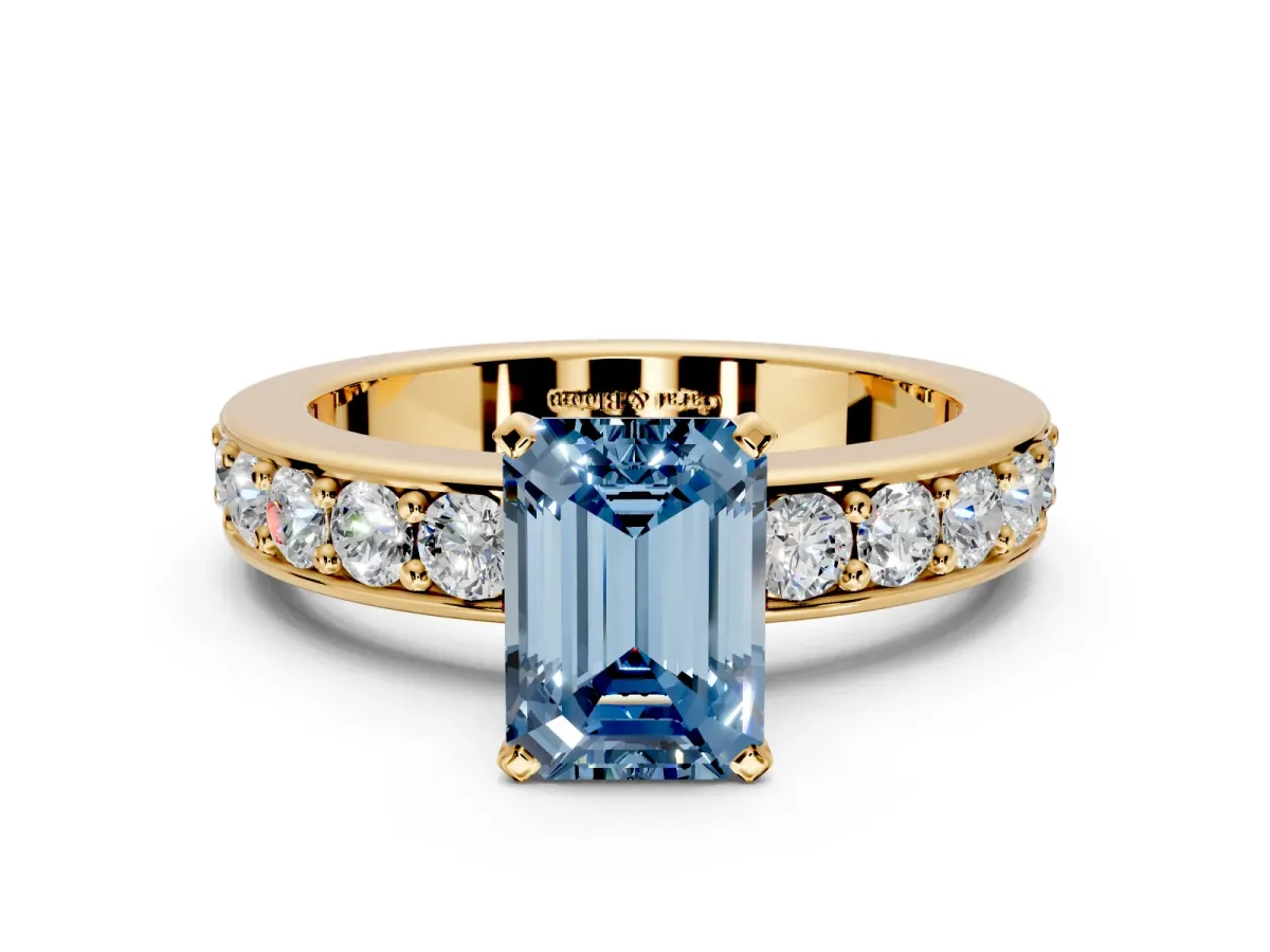 Solitaire Engagement Ring Setting for Fancy Blue Emerald Cut Center with Channel-Set Accents and Prong Head in Yellow Gold