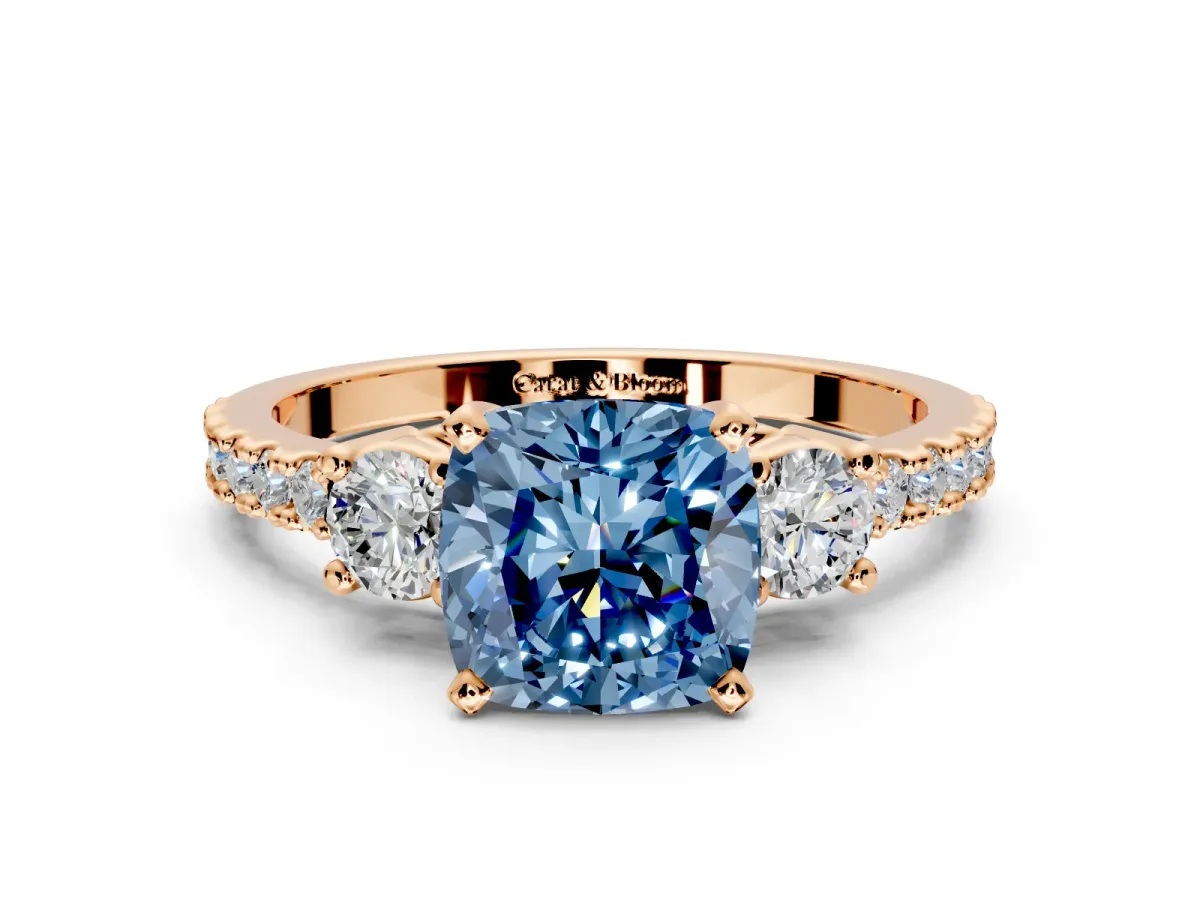 3 Stone Engagement Ring Setting for Fancy Blue Cushion Cut Center with Round Cut Side Accents and Prong Head in Rose Gold