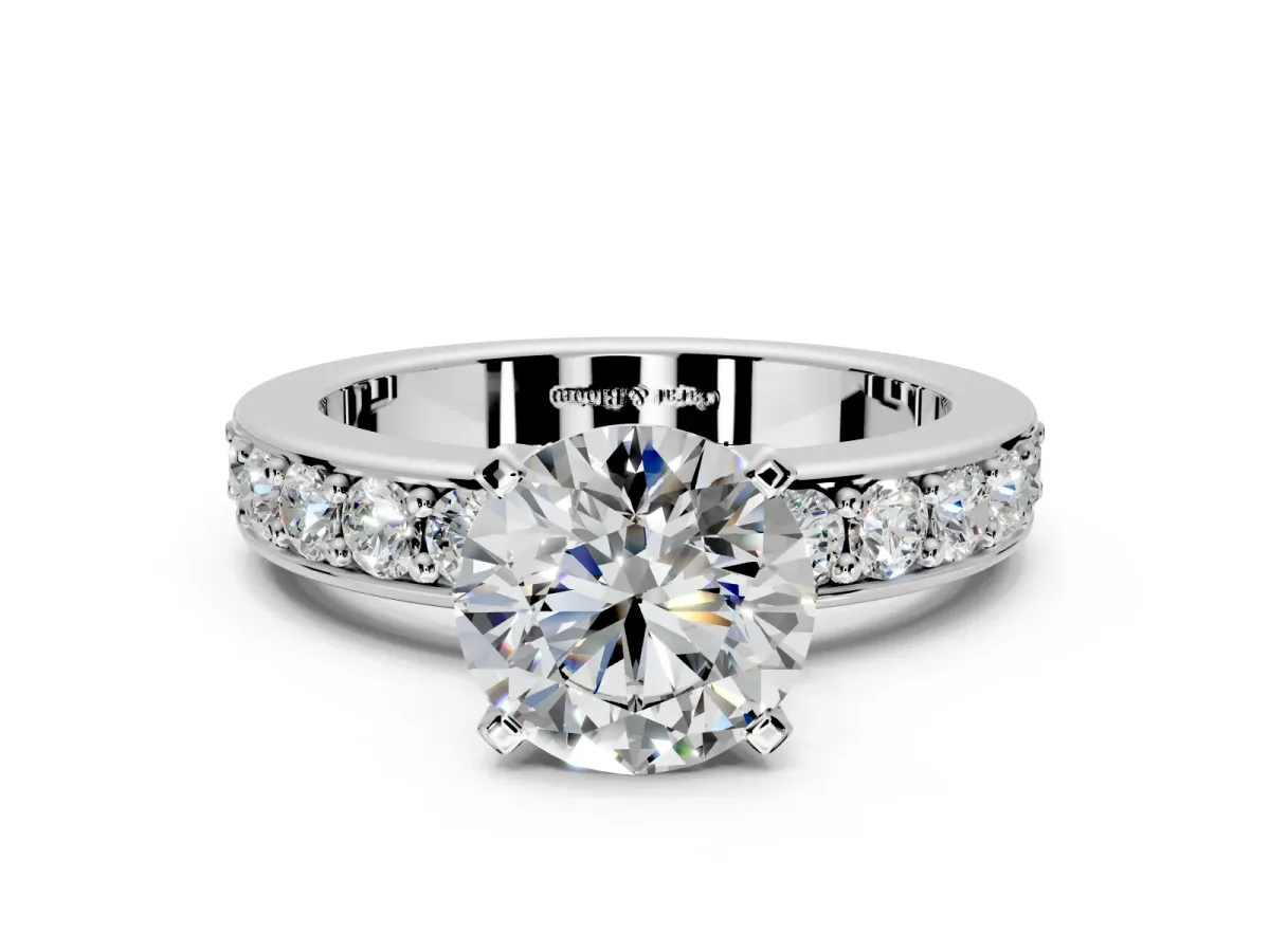 Solitaire Engagement Ring Setting for Round Cut Center with Channel-Set Accents and Prong Head in White Gold