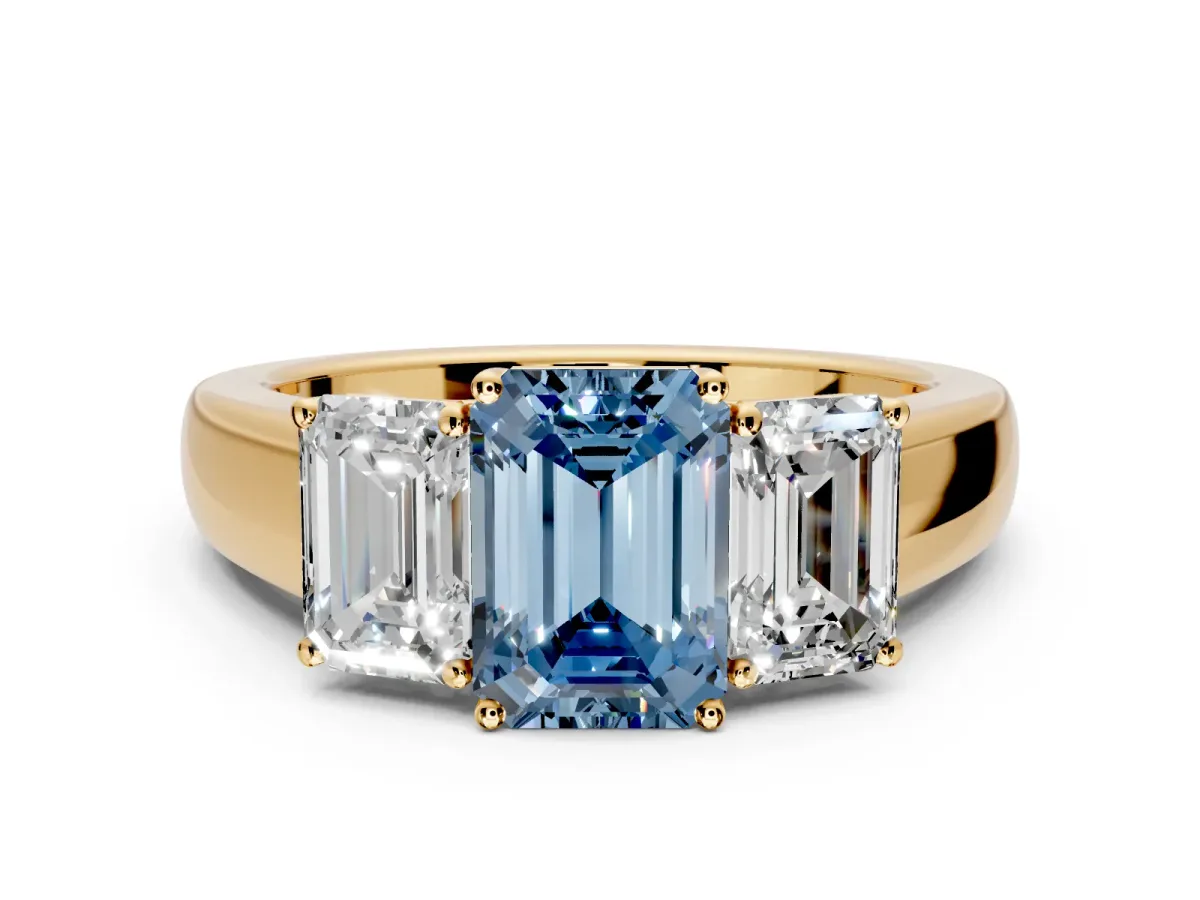 3 Stone Engagement Ring Setting for Fancy Blue Emerald Cut Center with Raised Basket Heads and Prong Head in Yellow Gold