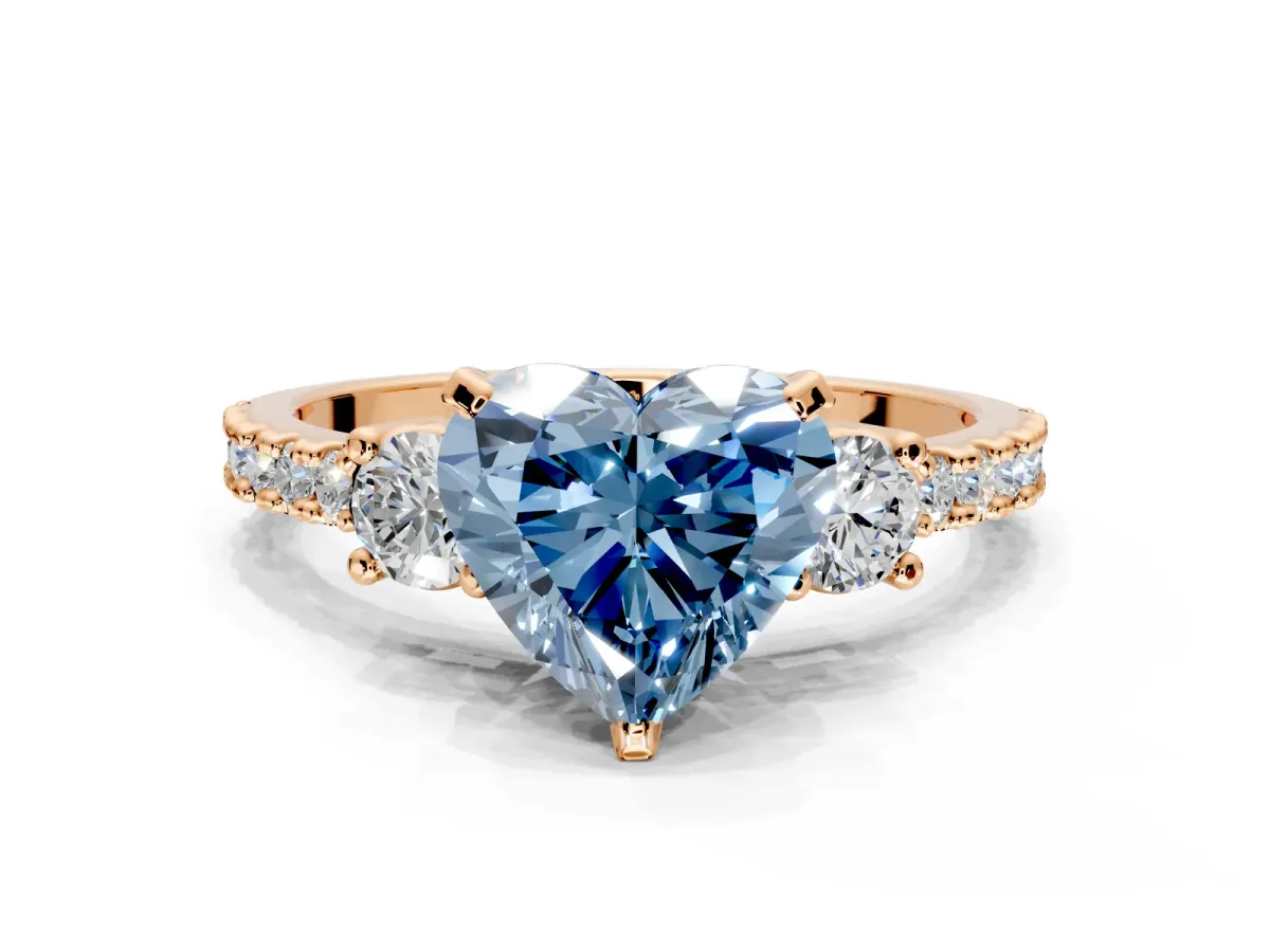 3 Stone Engagement Ring Setting for Fancy Blue Heart-Shaped Center with Round Cut Side Accents and Prong Head in Rose Gold
