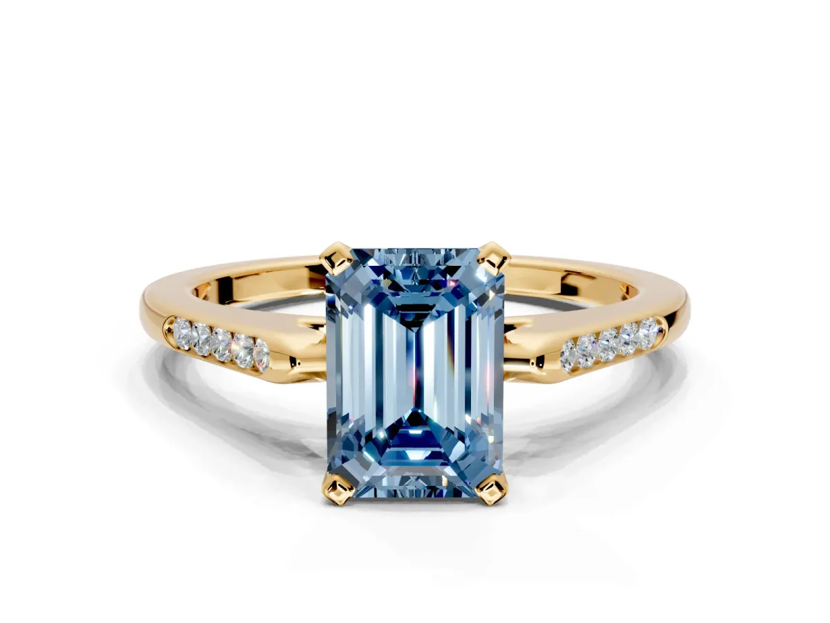 Solitaire Engagement Ring Setting for Fancy Blue Emerald Cut Center with Channel Accents and Prong Head in Yellow Gold