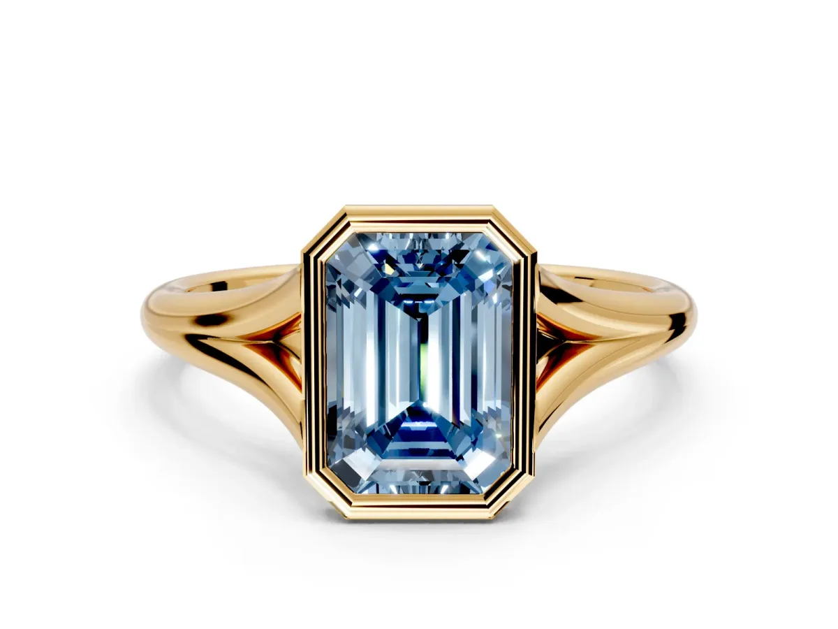 Solitaire Engagement Ring Setting for Fancy Blue Emerald Cut Center with V Split Shank and Bezel Head in Yellow Gold
