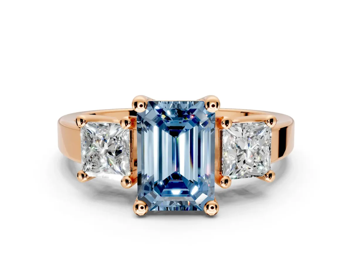 3 Stone Engagement Ring Setting for Fancy Blue Emerald Cut Center with Matching Side Accents and Prong Head in Rose Gold