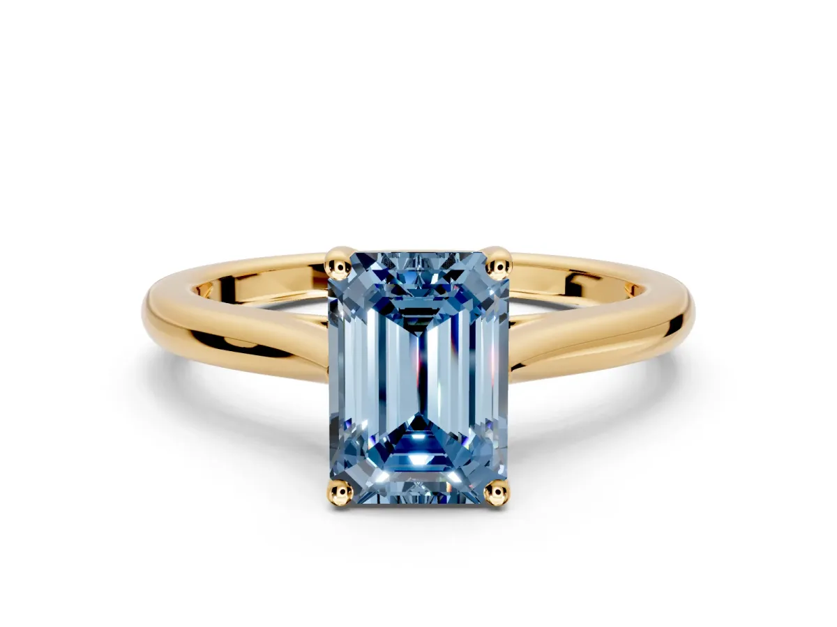 Solitaire Engagement Ring Setting for Fancy Blue Emerald Cut Center with Narrow Cathedral Band and Prong Head in Yellow Gold