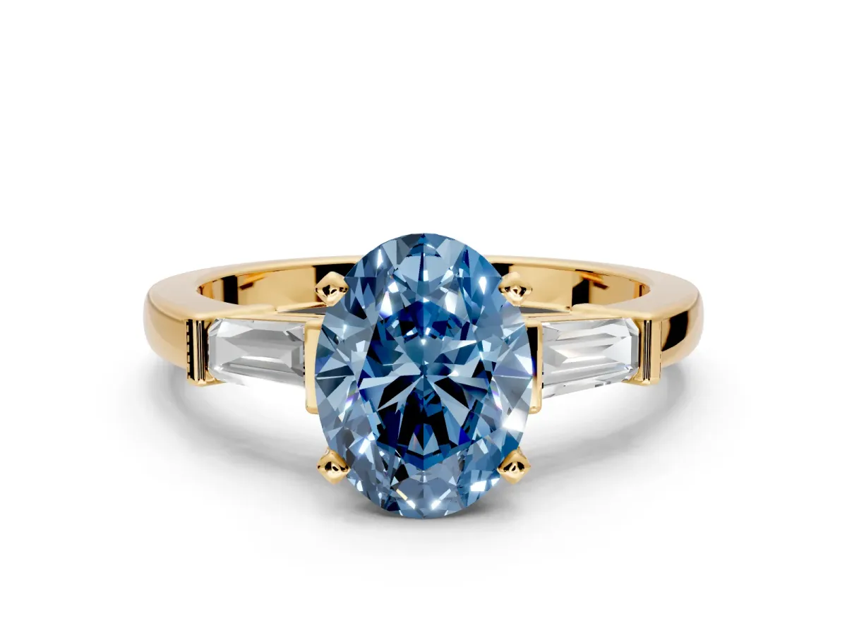 3 Stone Engagement Ring Setting for Fancy Blue Oval Center with Channel Baguette Accents and Prong Head in Yellow Gold