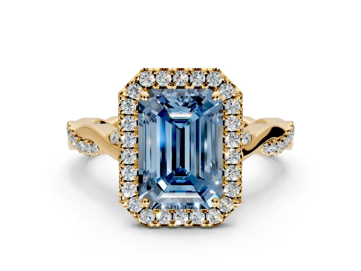 Halo Engagement Ring Setting for Fancy Blue Emerald Cut Center with Twist Band and Prong Head in Yellow Gold