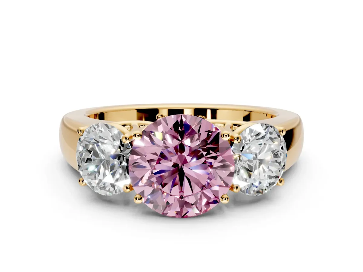 3 Stone Engagement Ring Setting for Fancy Pink Round Cut Center with Raised Basket Heads and Prong Head in Yellow Gold