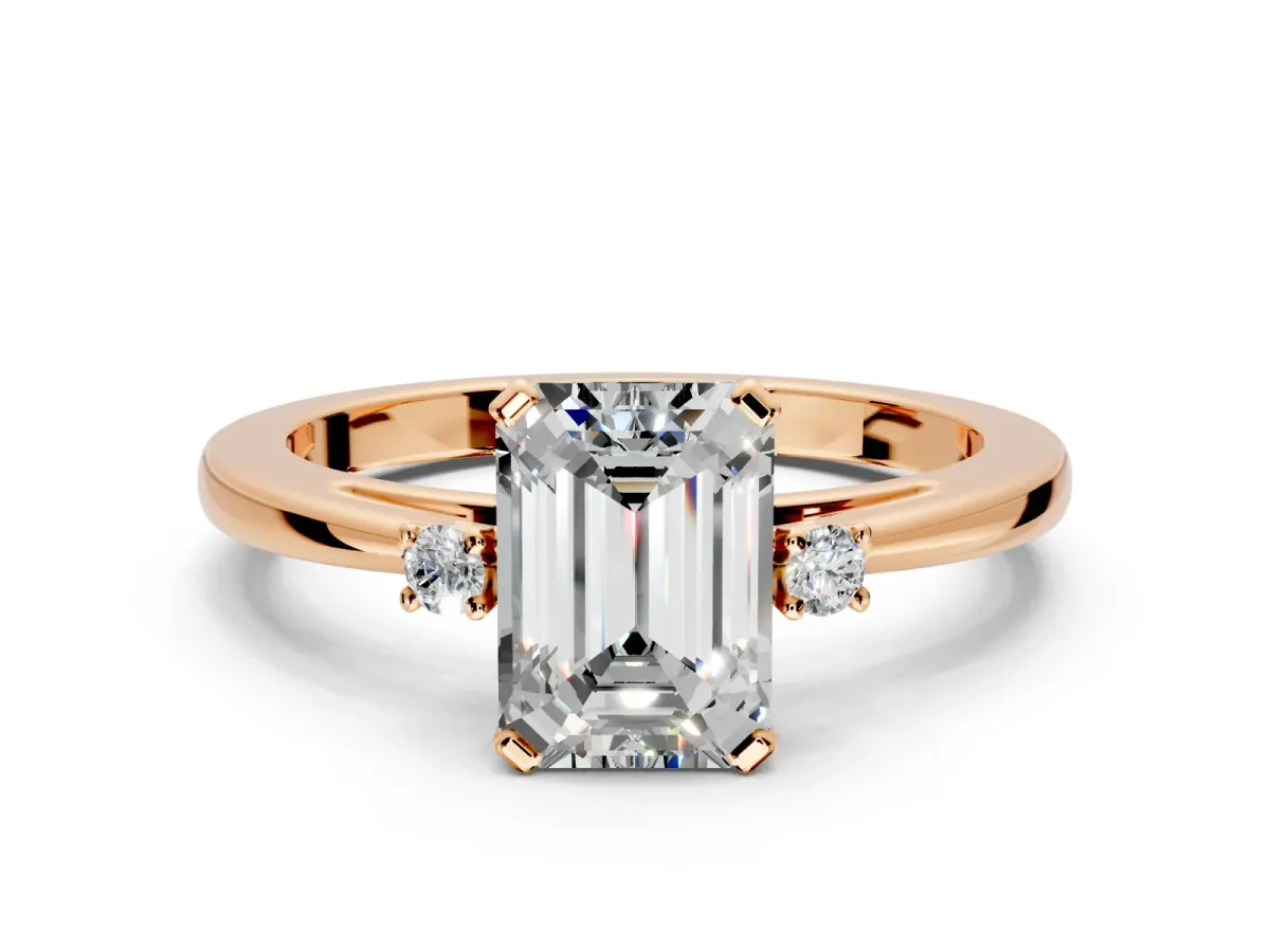 3 Stone Engagement Ring Setting for Emerald Cut Center with Low-Set Round Cut Accents and Prong Head in Rose Gold