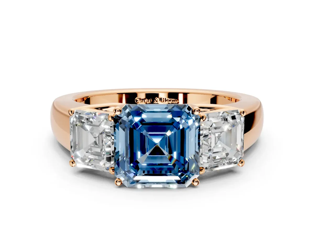 3 Stone Engagement Ring Setting for Fancy Blue Asscher Cut Center with Raised Basket Heads and Prong Head in Rose Gold