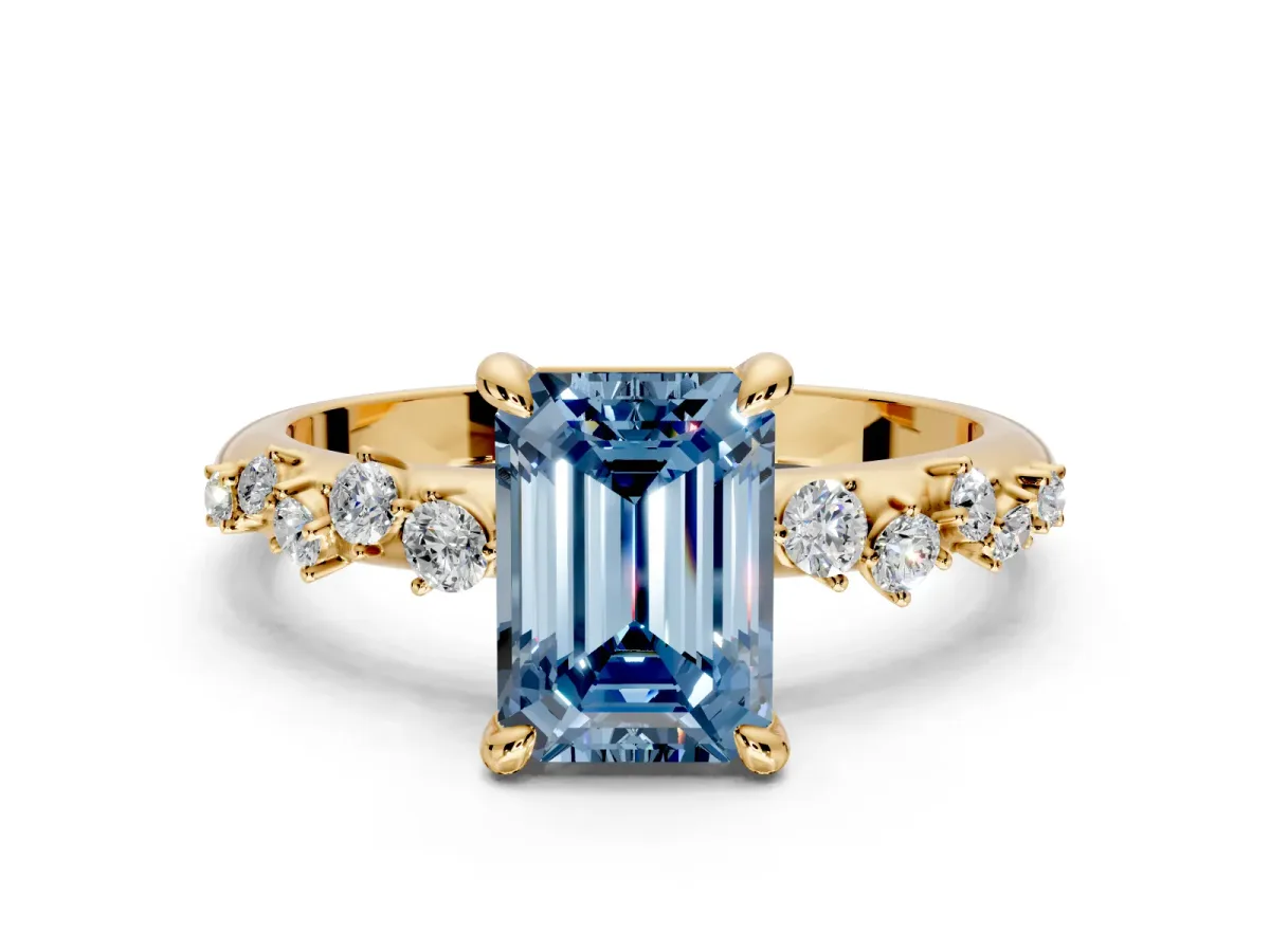 Solitaire Engagement Ring Setting for Fancy Blue Emerald Cut Center with Trailing Leaf Accent Band and Prong Head in Yellow Gold