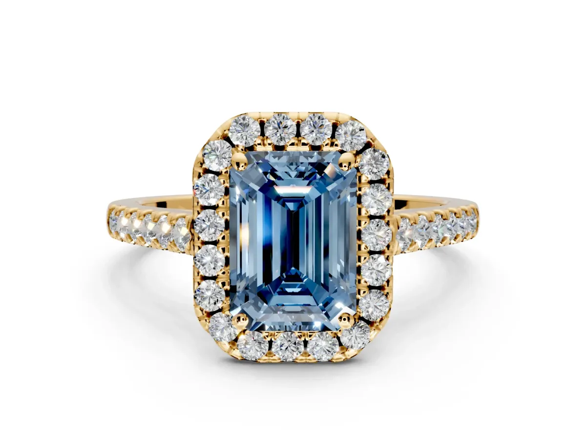 Halo Engagement Ring Setting for Fancy Blue Emerald Cut Center with Narrowing Pave Band and Prong Head in Yellow Gold