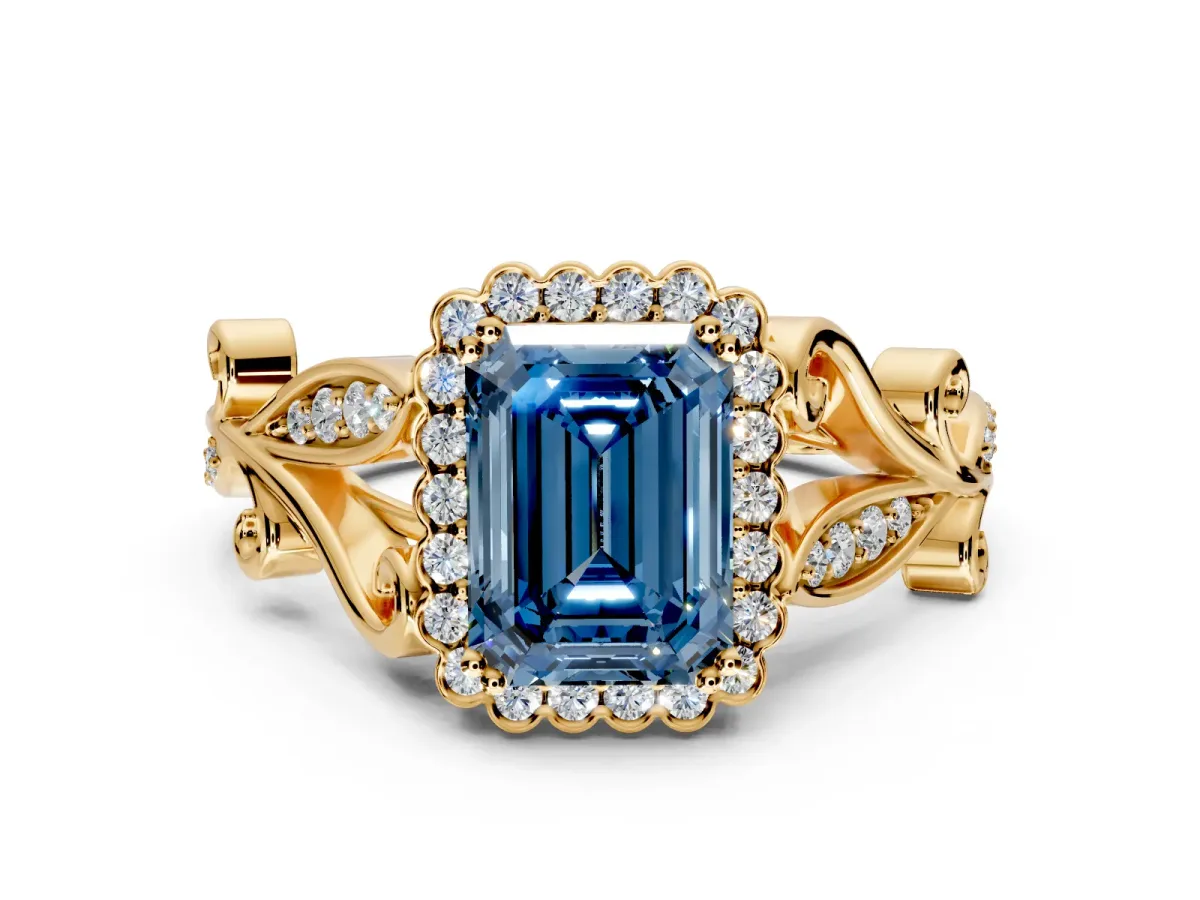 Halo Engagement Ring Setting for Fancy Blue Emerald Cut Center with Leaf Motif Split Shank and Prong Head in Yellow Gold