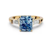 3 Stone Engagement Ring Setting for Fancy Blue Radiant Cut Center with Channel Baguette Accents and Prong Head in Yellow Gold