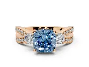 3 Stone Engagement Ring Setting for Fancy Blue Cushion Cut Center with Pave Twist Band and Prong Head in Rose Gold
