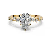 Cluster Engagement Ring Setting for Pear-Shaped Center with Round Cut Accent Band and Prong Head in Yellow Gold