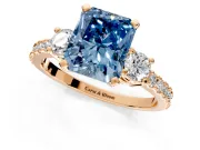3 Stone Engagement Ring Setting for Fancy Blue Radiant Cut Center with Round Cut Side Accents and Prong Head in Rose Gold