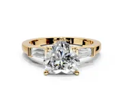 3 Stone Engagement Ring Setting for Heart-Shaped Center with Channel Baguette Accents and Prong Head in Yellow Gold