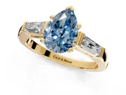 3 Stone Engagement Ring Setting for Fancy Blue Pear-Shaped Center with Tapered Baguettes, Plain Band and Prong Head in Yellow Gold