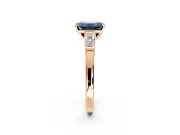 3 Stone Engagement Ring Setting for Fancy Blue Emerald Cut Center with Channel Baguette Accents and Prong Head in Rose Gold