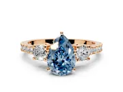 3 Stone Engagement Ring Setting for Fancy Blue Pear-Shaped Center with Round Cut Side Accents and Prong Head in Rose Gold