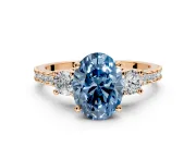 3 Stone Engagement Ring Setting for Fancy Blue Oval Center with Round Cut Side Accents and Prong Head in Rose Gold