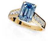 Solitaire Engagement Ring Setting for Fancy Blue Emerald Cut Center with Round Cut Channel Band and Prong Head in Yellow Gold