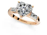 3 Stone Engagement Ring Setting for Heart-Shaped Center with Tapered Baguettes, Plain Band and Prong Head in Rose Gold