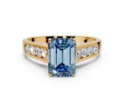 Solitaire Engagement Ring Setting for Fancy Blue Emerald Cut Center with Cathedral Channel Band and Prong Head in Yellow Gold