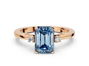 3 Stone Engagement Ring Setting for Fancy Blue Emerald Cut Center with Low-Set Round Cut Accents and Prong Head in Rose Gold