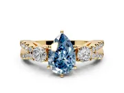 3 Stone Engagement Ring Setting for Fancy Blue Pear-Shaped Center with Pave Split Shank and Prong Head in Yellow Gold