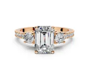3 Stone Engagement Ring Setting for Emerald Cut Center with Round Cut Side Accents and Prong Head in Rose Gold