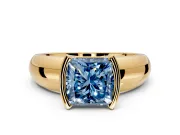 Tension Engagement Ring Setting for Fancy Blue Princess Cut Center with Wide Flat Band and Tension Head in Yellow Gold