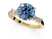 3 Stone Engagement Ring Setting for Fancy Blue Round Cut Center with Channel Baguette Accents and Prong Head in Yellow Gold
