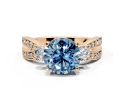 3 Stone Engagement Ring Setting for Fancy Blue Round Cut Center with Pave Twist Band and Prong Head in Rose Gold