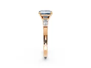 3 Stone Engagement Ring Setting for Fancy Blue Princess Cut Center with Channel Baguette Accents and Prong Head in Rose Gold