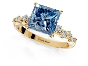Cluster Engagement Ring Setting for Fancy Blue Princess Cut Center with Round Cut Accent Band and Prong Head in Yellow Gold