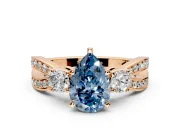 3 Stone Engagement Ring Setting for Fancy Blue Pear-Shaped Center with Pave Twist Band and Prong Head in Rose Gold
