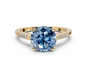 Solitaire Engagement Ring Setting for Fancy Blue Round Cut Center with Channel Accents and Prong Head in Yellow Gold