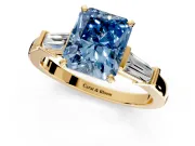 3 Stone Engagement Ring Setting for Fancy Blue Radiant Cut Center with Channel Baguette Accents and Prong Head in Yellow Gold
