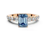 Shared-Prong Engagement Ring Setting for Fancy Blue Emerald Cut Center with Graduated Accents and Prong Head in Rose Gold