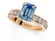 Solitaire Engagement Ring Setting for Fancy Blue Emerald Cut Center with Channel-Set Accents and Prong Head in Rose Gold