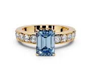 Solitaire Engagement Ring Setting for Fancy Blue Emerald Cut Center with Channel-Set Accents and Prong Head in Yellow Gold