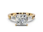 3 Stone Engagement Ring Setting for Princess Cut Center with Channel Baguette Accents and Prong Head in Yellow Gold