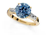 3 Stone Engagement Ring Setting for Fancy Blue Round Cut Center with Tapered Baguettes, Plain Band and Prong Head in Yellow Gold