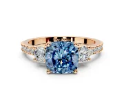 3 Stone Engagement Ring Setting for Fancy Blue Cushion Cut Center with Round Cut Side Accents and Prong Head in Rose Gold